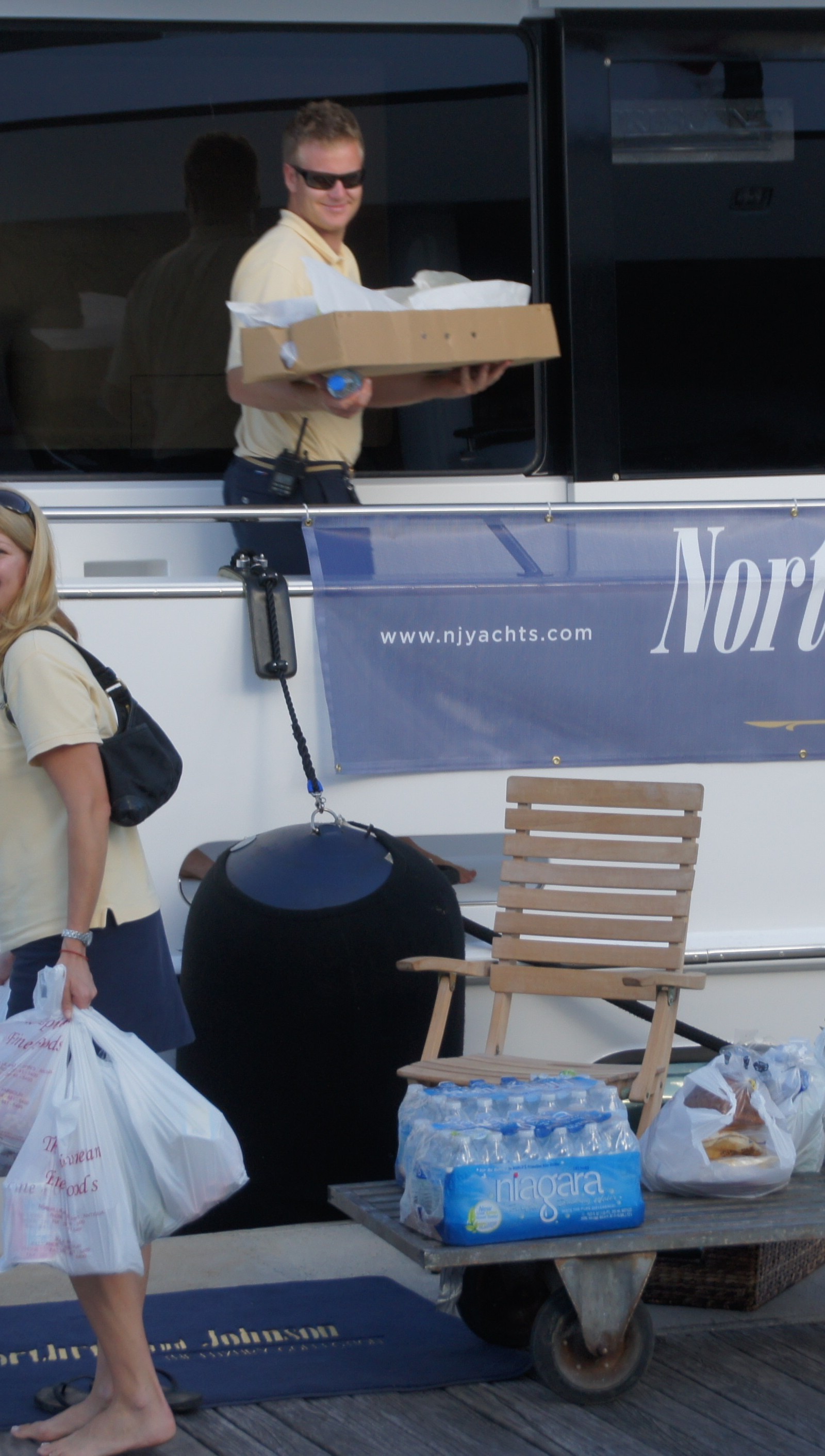 Superyacht crew bringing provisions onboard after a shopping trip.