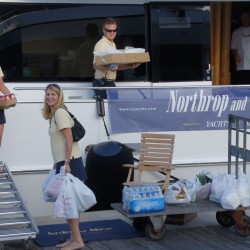 Superyacht crew bringing provisions onboard after a shopping trip.