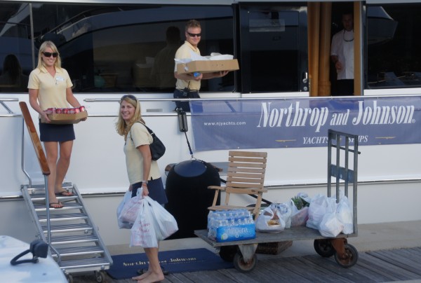 Superyacht crew bringing provisions onboard after a shopping trip.
