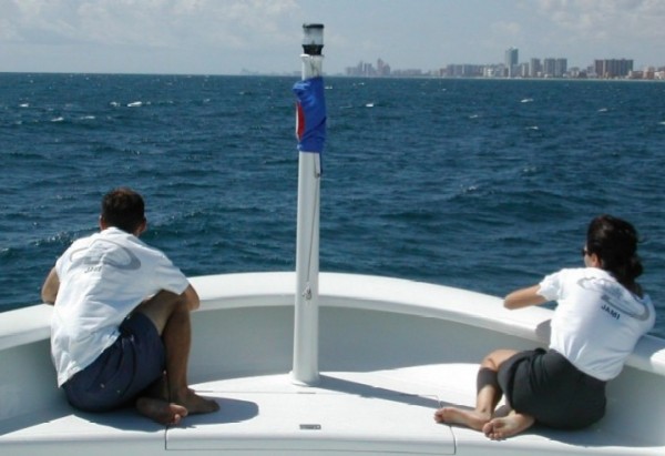 Megayacht crew taking a break on the bow as they sail around Miami.