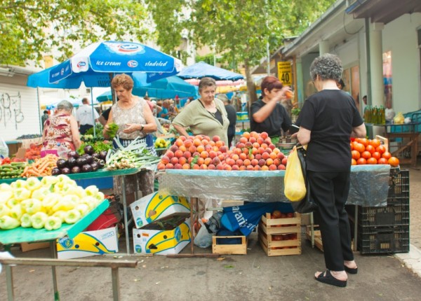 People buying local produce at a farmer's market in Split, Croatia.