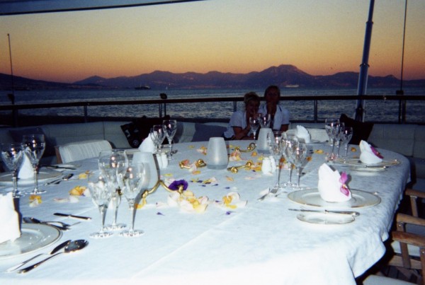 Julie and a fellow stew decorating the table for guests off the coast of Napoli (Naples), Italy.